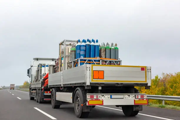 Photo of Transportation of cylinders with oxygen for patients with coronavirus. Truck delivering gas cylinders for medical purposes