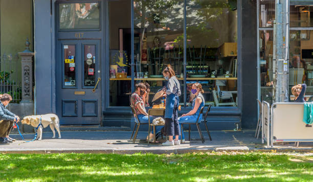 Diners are using outdoor restaurant seating Melbourne, Victoria, Australia, November 1st, 2020: Diners are using outdoor restaurant seating in Melbourne under social distancing rules in the wake of the Covid-19 pandemic melbourne street crowd stock pictures, royalty-free photos & images