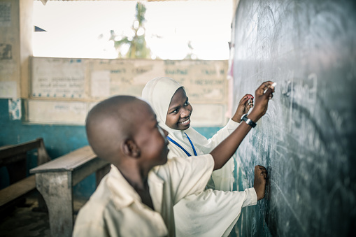 family of african kids in the village eating