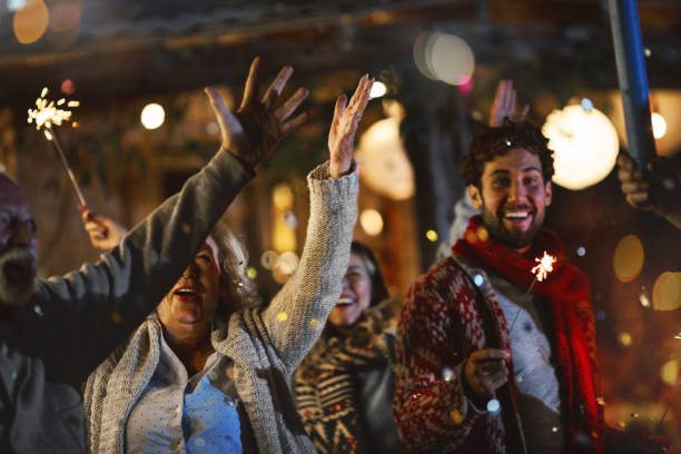 Family New Year Party. Family dancing and celebrating New Year outdoors. firework display pyrotechnics celebration excitement stock pictures, royalty-free photos & images