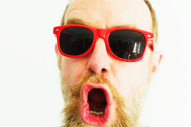 istock Man wearing novelty red sunglasses looks surprised or horrified 1283322113