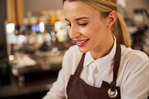 istock Happy smiling woman looking away while standing in the indoors 1283322199