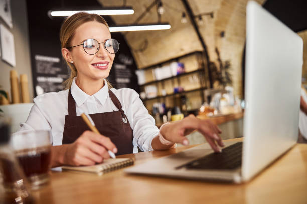 istock Happy smiling lady in uniform using laptop in the job 1283322237
