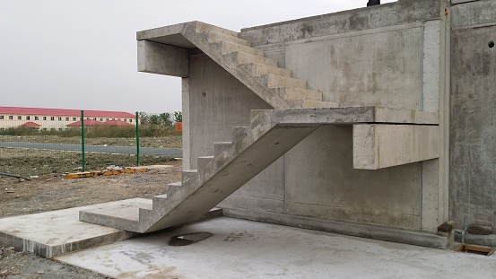 Picture of straight precast concrete stairs with landings completely installed on a building in the shell during the day