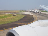 Picture of several airplanes on an airport runway waiting for takeoff clearance