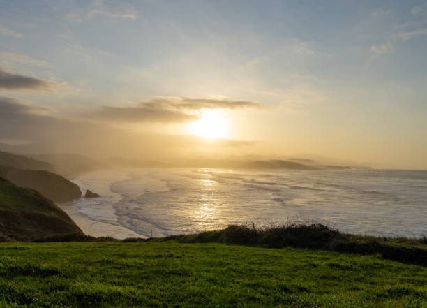 istock green grassy cliffs drop down to the ocean coast in northern Spain at sunset 1283324151