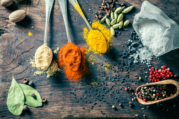 istock Top view of colorful herbs and spices on old board 1283324197