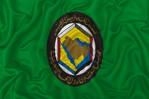 Gulf Cooperation Council flag on wavy silk textile fabric background. 3D Illustration.