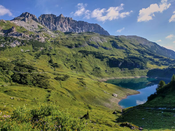 istock Panoramic view on a mountain lake in Austria. Formarinsee in Austria. Panoramic mountain lake in the alps. Reflecting mountain lake. 1283324895