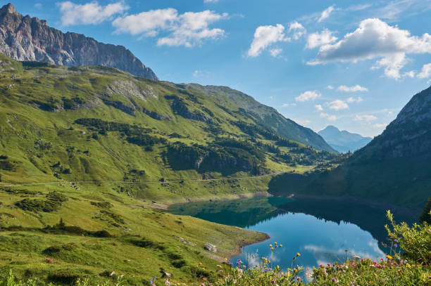 istock Panoramic view on a mountain lake in Austria. Formarinsee in Austria. Panoramic mountain lake in the alps. Reflecting mountain lake. 1283324938