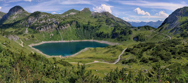 istock Panoramic view on a mountain lake in Austria. Formarinsee in Austria. Panoramic mountain lake in the alps. Reflecting mountain lake. 1283325832