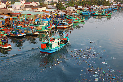 Duong Dong, Phu Quoc island, Vietnam - March 26, 2019: pile of garbage in a dirty city river