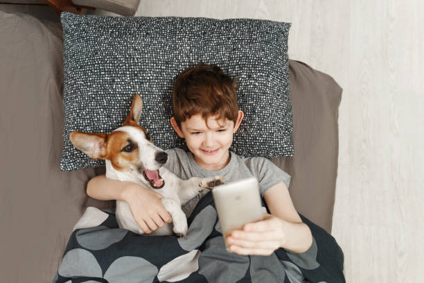 istock Little boy takes a selfie with a dog. 1283328571
