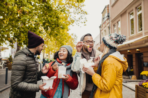 istock Friends outdoors eating fast food and having fun 1283328634