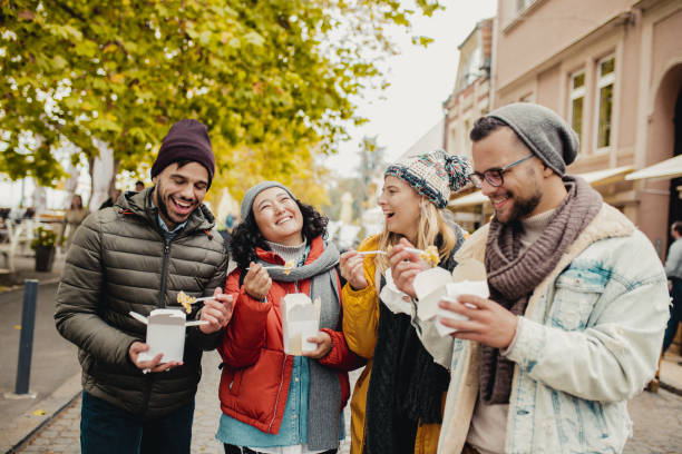 istock Friends outdoors eating fast food and having fun 1283328657