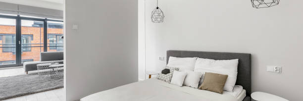 istock Bedroom open to living room, panorama 1283329636