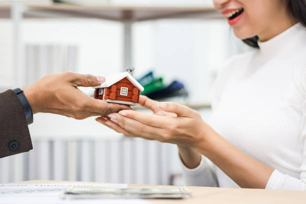 istock Excited female feeling euphoric celebrating after successful agreement signing contract real estate with bank empoyees. Property investment and house mortgage financial real estate concept. 1283331390