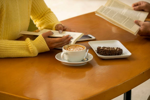 istock Lovers are reading a book and having a good time while drinking coffee in the cafe. 1283332555