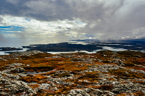 Autumn colorful tundra on the background mountain peaks in cloudy weather. Mountain landscape in Kola Peninsula, Arctic, Khibiny Mountains. photo