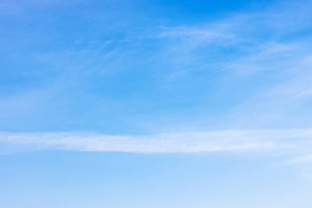 istock old blurred contrail and cirrus clouds in blue sky 1283332652
