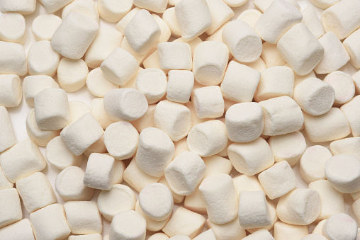 Closeup of a group of white mini marshmallows filling the frame.