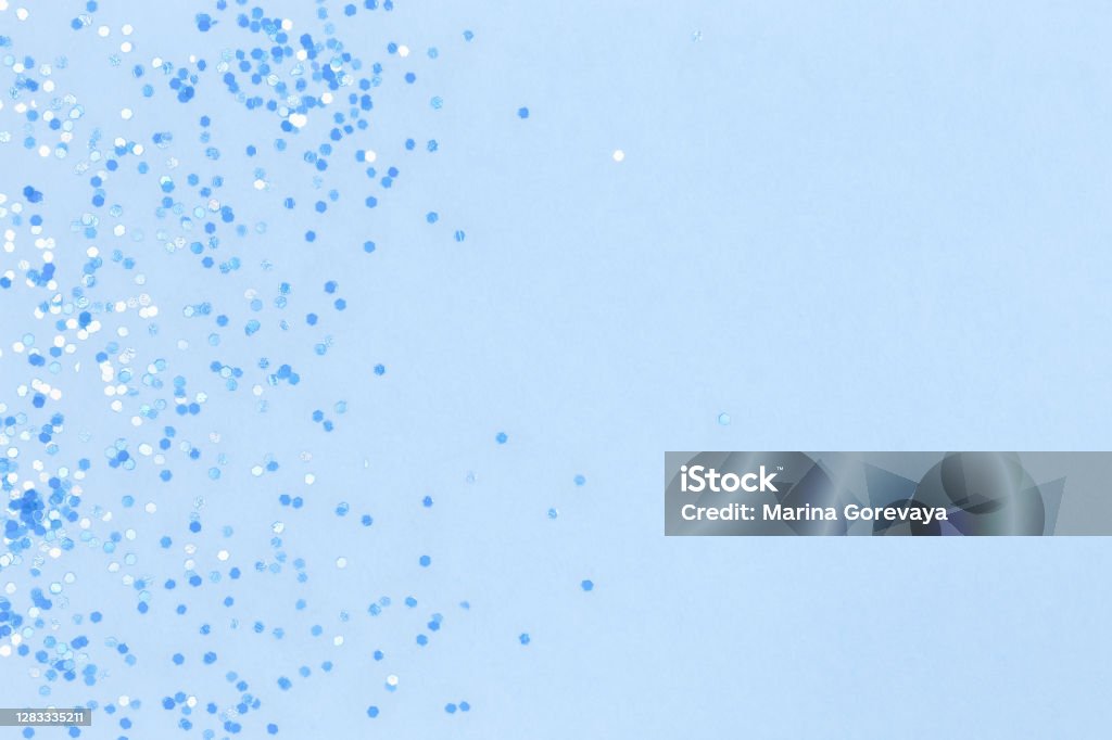 Blue background with sequins. Suitable for backdrop for your design. Top view, copy space. Blue background with sequins. Suitable for backdrop for your design. Top view, copy space Confetti Stock Photo