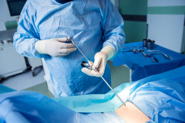 Surgeon performs endoscopic microdiscectomy of herniated intervertebral disc. stock photo