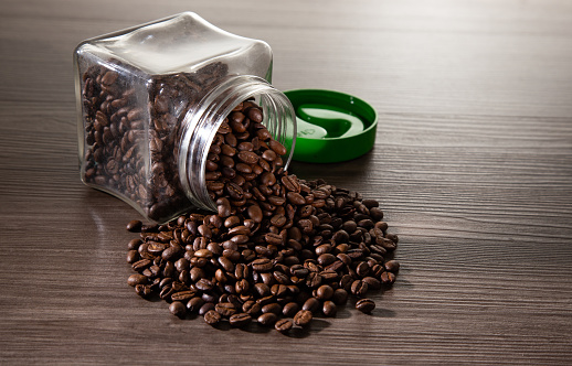 coffee beans in the glass jar on dark background