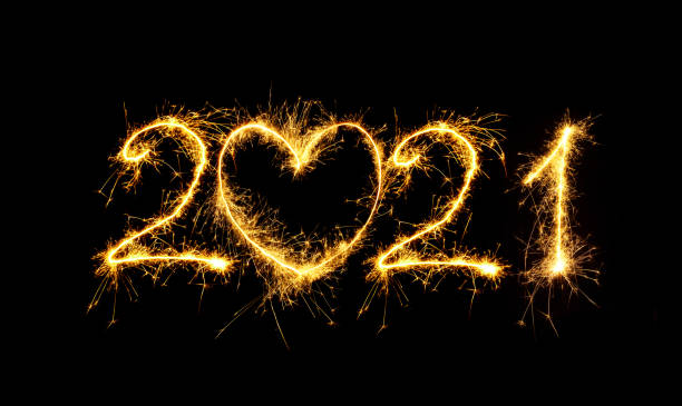 Creative Number 2021 with sign heart written sparkling sparklers