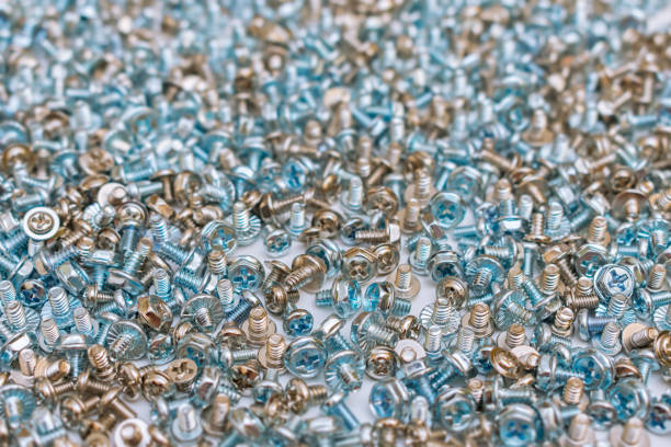A huge amount of bolts and screws lying in a common unsorted pile in the workshop