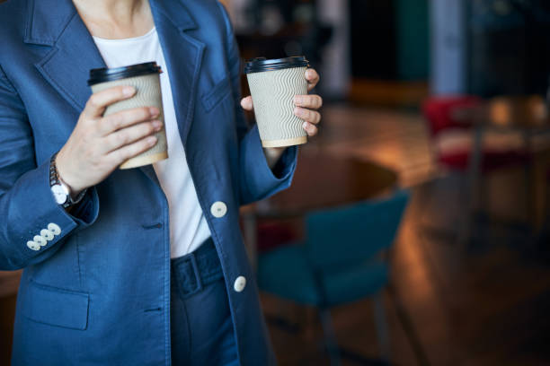 istock Elegant woman holding two cups of coffee 1283340904