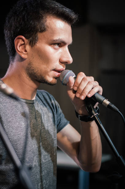 istock Theater audio technician adjusting an microphones on the scene 1283340965