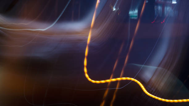 istock Light trails from panning on the streets at night. 1283341295