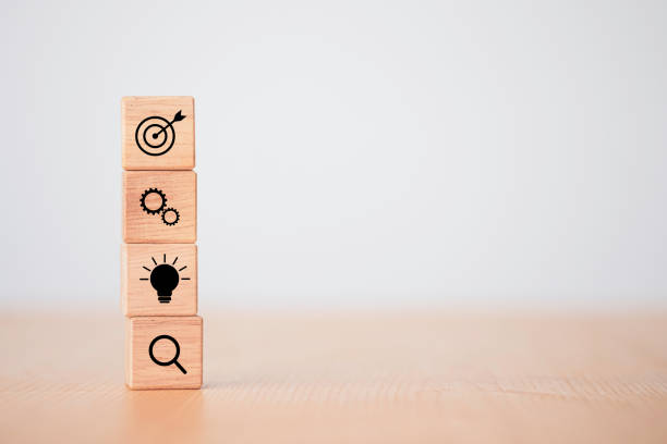 istock Achievement business target concept , stacking wooden cubes block which print screen target , mechanical gear , light bulb. 1283342625