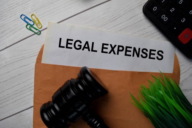 istock Legal Expenses text with document brown envelope and gavel isolated on office desk. 1283342886