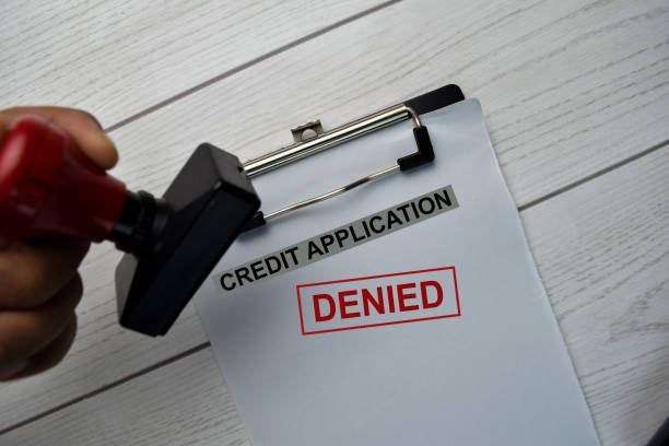 istock Red Handle Rubber Stamper and Credit Application - Denied text isolated on the table. 1283343012