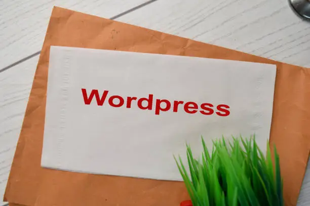 Photo of Wordpress write on the tissue with wooden table background