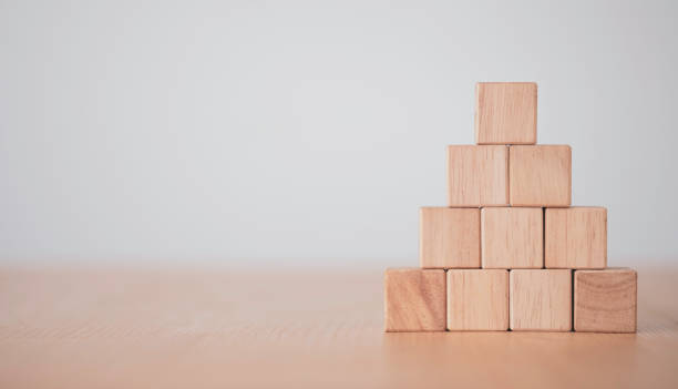 istock Hand putting and stacking blank wooden cubes on table with copy space for input wording and infographic icon. 1283343809