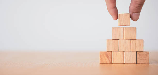 istock Hand putting blank wooden stacking on table , Use for add text and icons. 1283343847