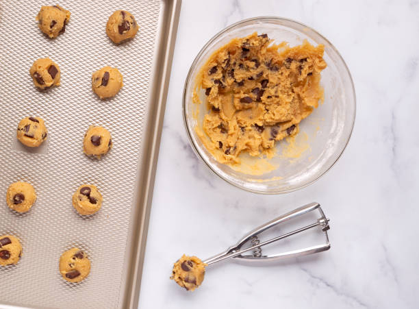 istock Chocolate chip cookie dough with scooper and baking pan 1283344960