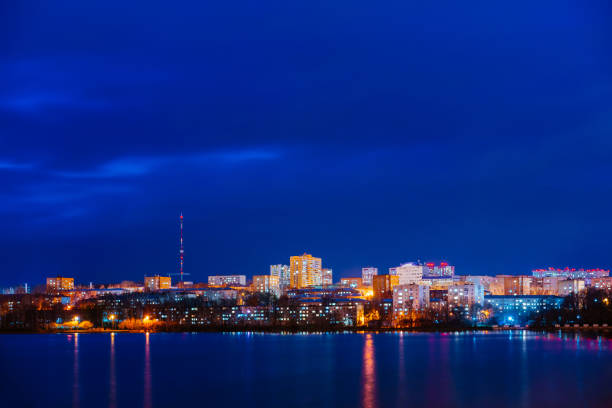 A night panorama of city with illuminated buildings. Izhevsk pond.