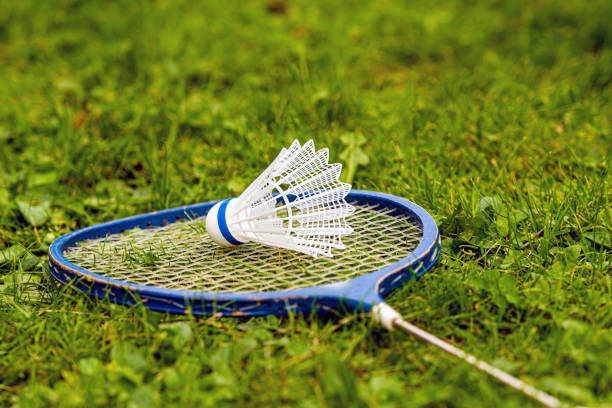 istock badminton rackets and birdie on green grass 1283344992