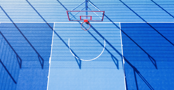 Minimalistic abstract background of blue basketball court at daylight. Aerial view.