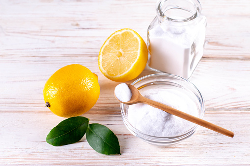 Natural products for eco friendly home cleaner, lemon, vinegar, baking soda. Homemade green cleaning.