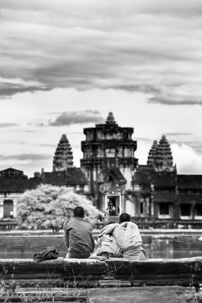 Image in Angkor Wat complex temple with Buddhist monks. Siam Reap, Siam Reap / Cambodia - September 30th 2016: Image in Angkor Wat complex temple with Buddhist monks. black and white travel travel destinations monk stock pictures, royalty-free photos & images