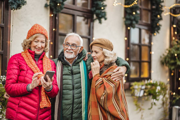 istock Group of seniors outdoors using mobile phone 1283348148