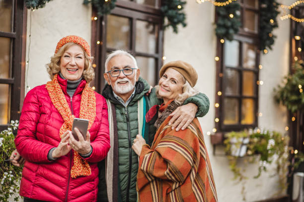 istock Group of seniors outdoors using mobile phone 1283348233