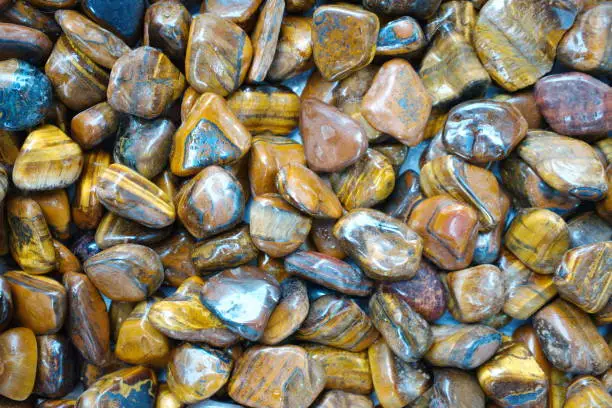 Tiger eye mineral stone. used in jewelry, accessories and mining. natural stones background