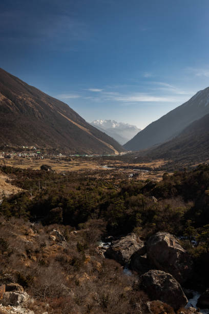 istock himalayan valley leading to snow peak with blue sky 1283348847