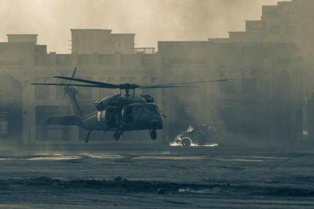 military combat and war with helicopter landing in the chaos and destruction. smoke and fire on the ground. military concept of power, force, strength, air raid. - air raid imagens e fotografias de stock
